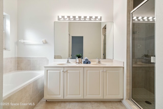 bathroom featuring plus walk in shower, vanity, and tile patterned flooring