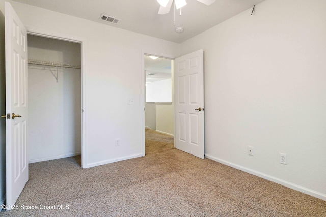 unfurnished bedroom featuring ceiling fan, light colored carpet, and a closet