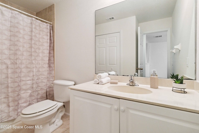 bathroom featuring tile patterned floors, vanity, and toilet