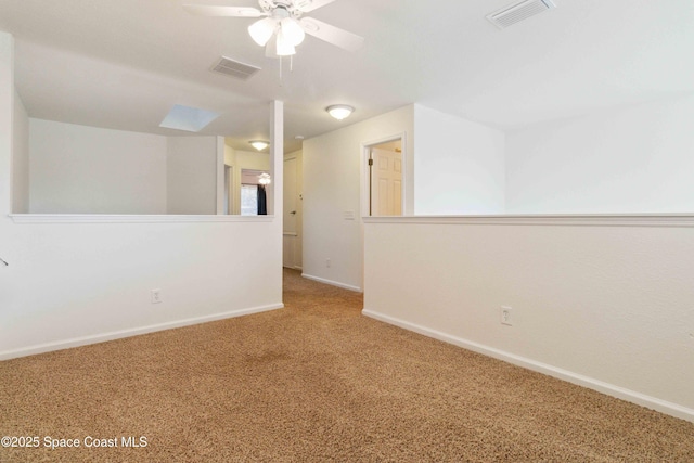 carpeted empty room featuring ceiling fan