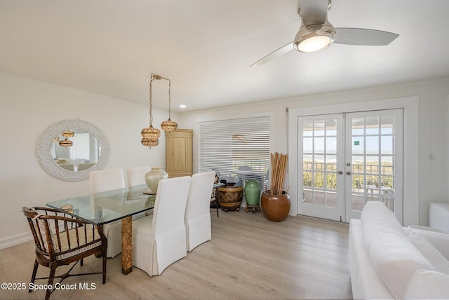 dining area with french doors, ceiling fan, and light wood-type flooring