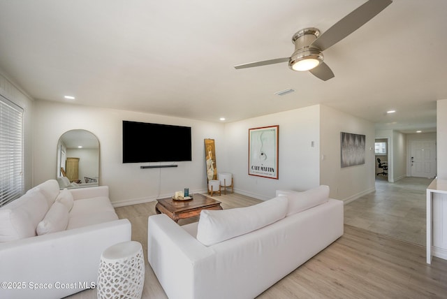 living room featuring ceiling fan and light wood-type flooring