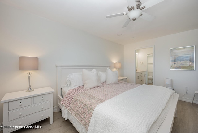 bedroom with ceiling fan, ensuite bathroom, and light wood-type flooring