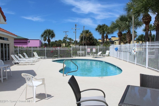 view of swimming pool featuring a patio area