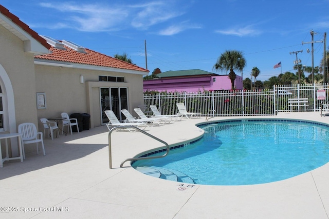 view of swimming pool with a patio area