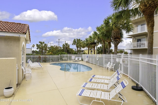 view of swimming pool with a patio