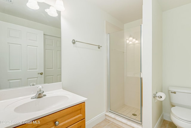 bathroom featuring a shower with door, toilet, tile patterned floors, and vanity