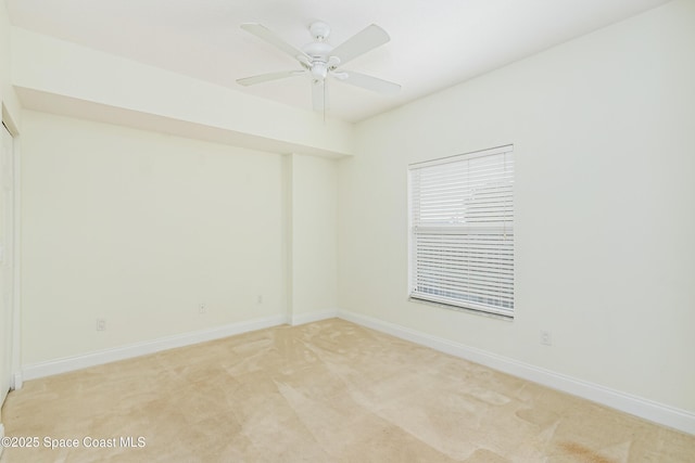 empty room with ceiling fan and light colored carpet