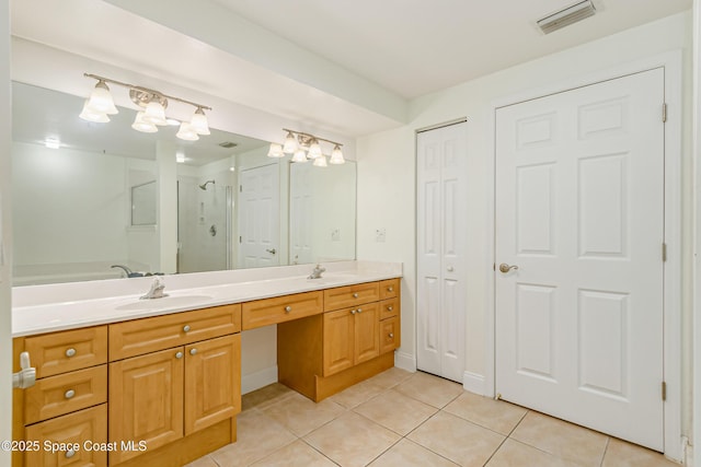 bathroom featuring vanity, tile patterned floors, and a shower with door