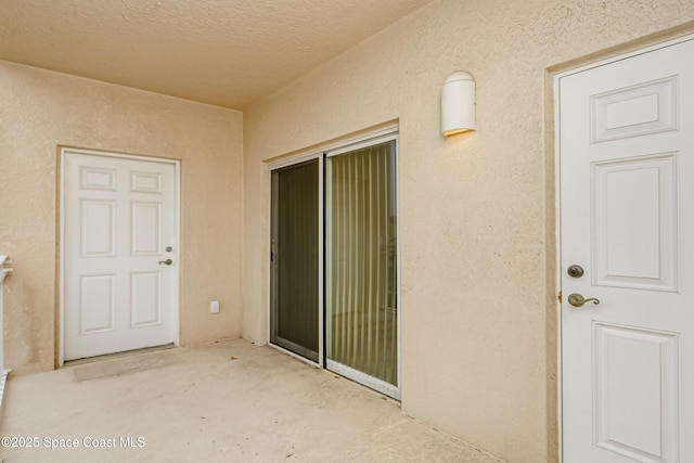 property entrance featuring a patio area