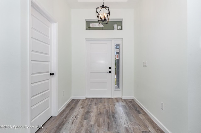 entryway with hardwood / wood-style flooring and an inviting chandelier