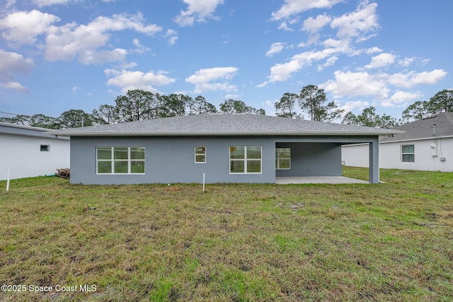 rear view of property with a lawn and a patio