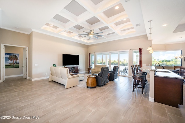 living room featuring a towering ceiling, beam ceiling, ceiling fan, coffered ceiling, and sink