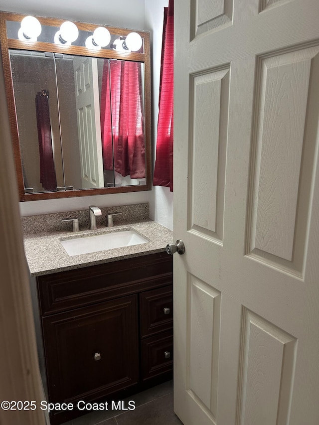 bathroom with tile patterned flooring and vanity