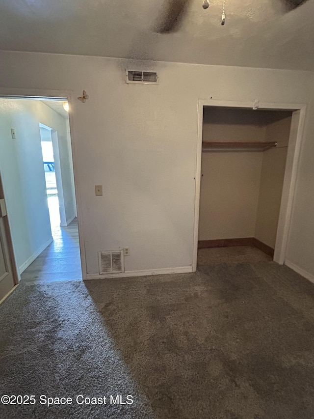 unfurnished bedroom featuring carpet flooring and a closet