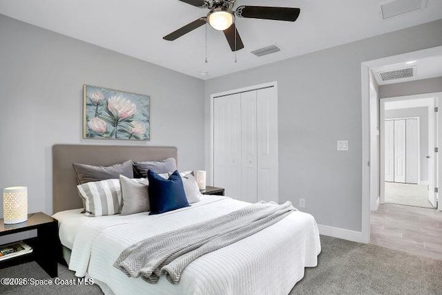 carpeted bedroom featuring a closet and ceiling fan