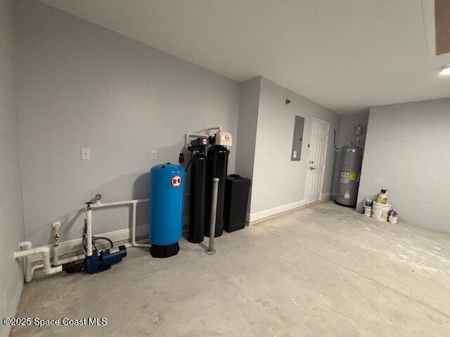 garage featuring electric panel and water heater