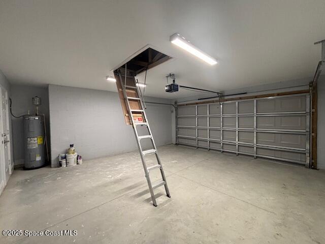 garage featuring water heater and a garage door opener