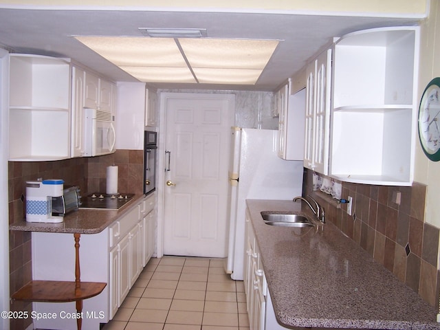 kitchen with sink, light tile patterned floors, white cabinetry, tasteful backsplash, and black appliances