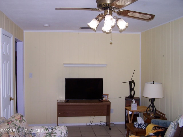 tiled living room featuring ornamental molding and ceiling fan