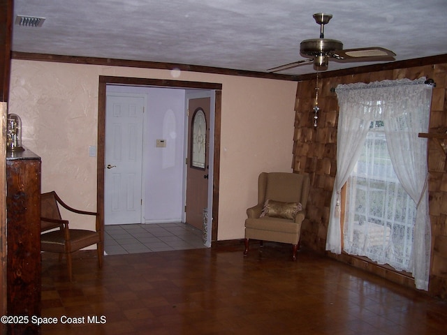 entryway with a textured ceiling and ceiling fan