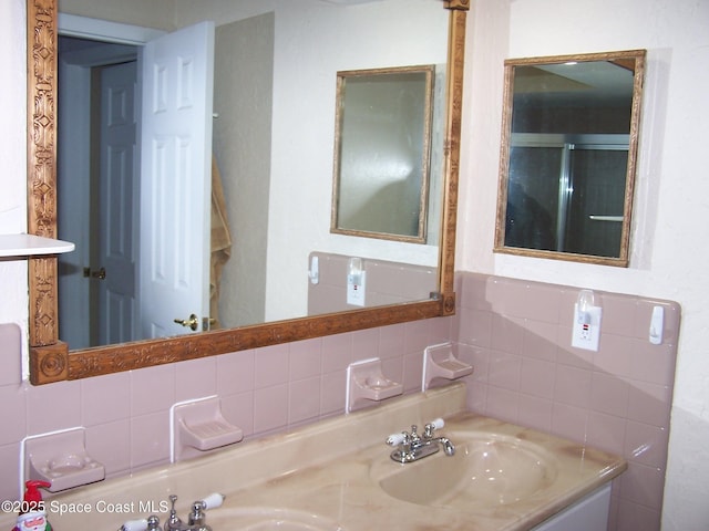 bathroom featuring tasteful backsplash and vanity