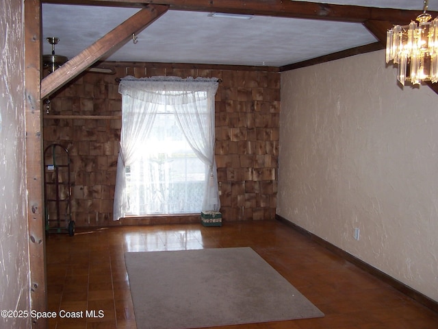 empty room featuring a notable chandelier