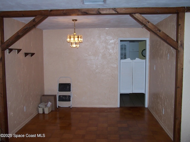 interior space featuring a notable chandelier and dark parquet floors