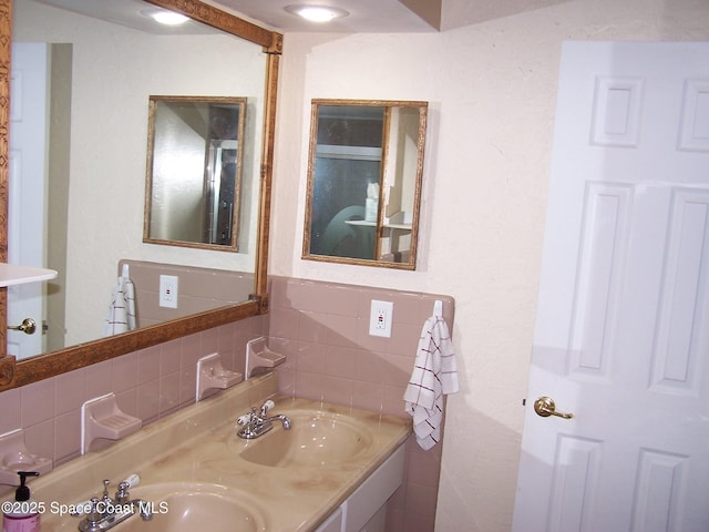 bathroom featuring vanity and backsplash