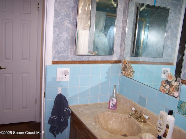 bathroom with vanity and tile walls