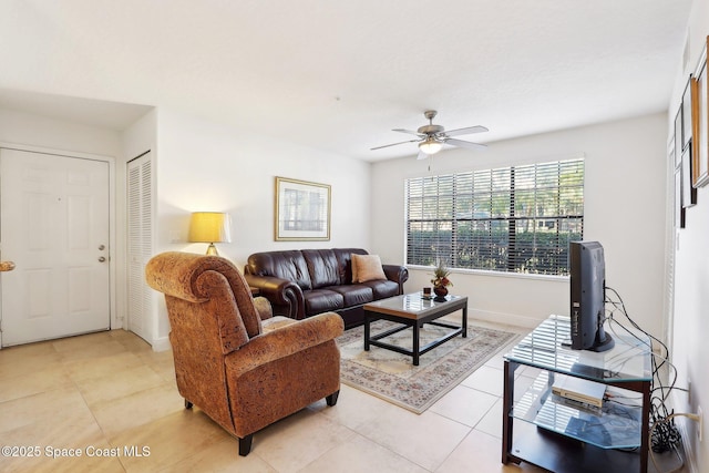 tiled living room featuring ceiling fan