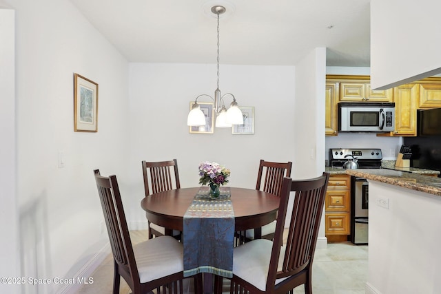 dining area with an inviting chandelier