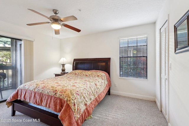 carpeted bedroom with ceiling fan, access to exterior, and a closet