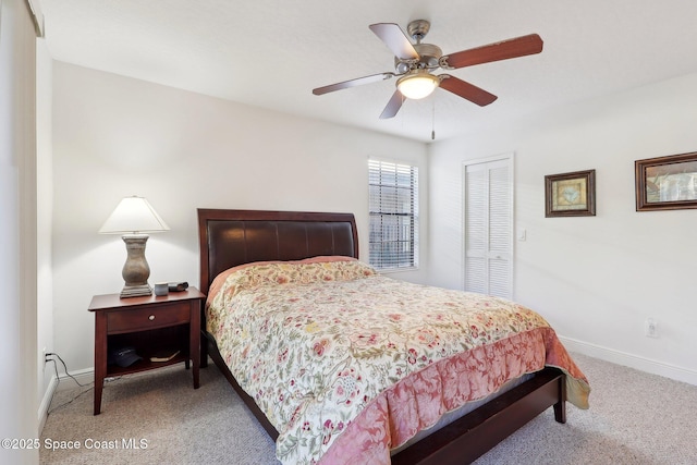 bedroom featuring ceiling fan, a closet, and carpet