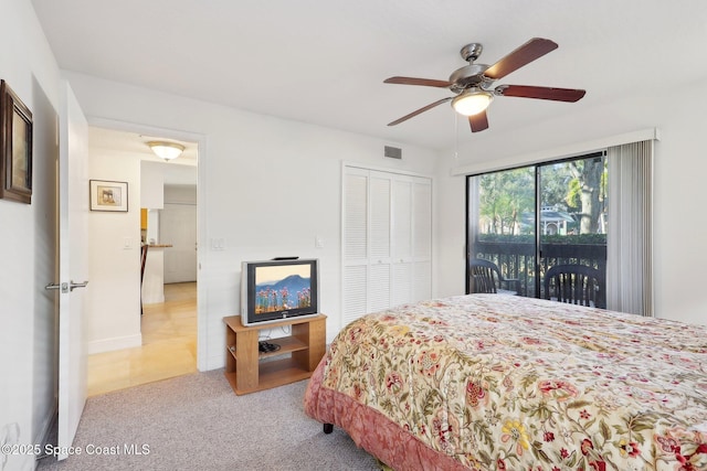 carpeted bedroom featuring access to outside, ceiling fan, and a closet