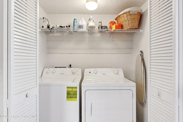 laundry area featuring a textured ceiling and separate washer and dryer