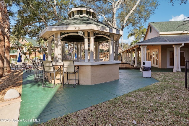 view of patio with a gazebo and exterior bar