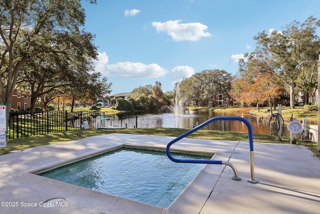 view of swimming pool with a water view