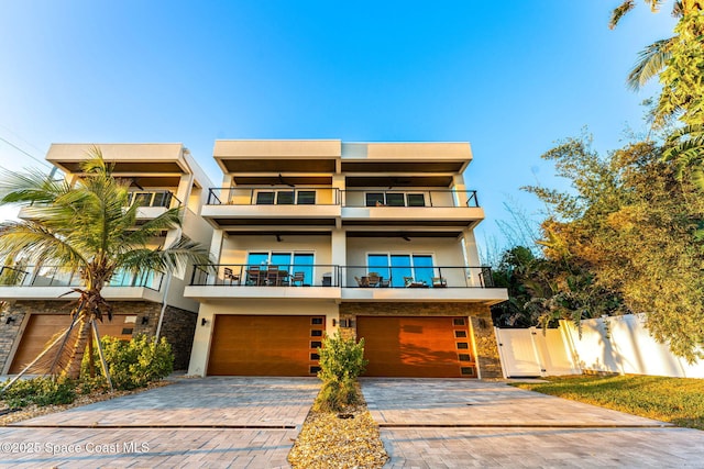 view of front of home featuring a balcony and a garage