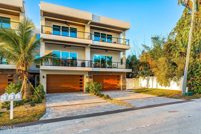 contemporary house featuring a garage and a balcony