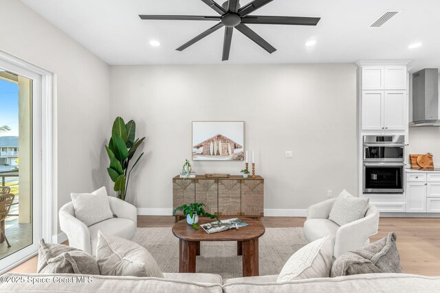 living room with light hardwood / wood-style flooring and a healthy amount of sunlight