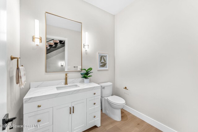 bathroom featuring hardwood / wood-style floors, toilet, and vanity