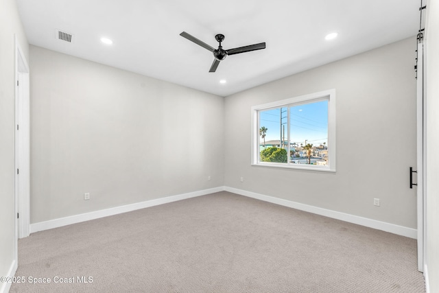 empty room featuring light carpet and ceiling fan