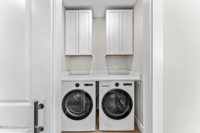 washroom with cabinets and independent washer and dryer