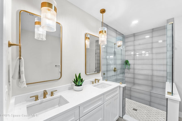 bathroom featuring a shower with door and vanity