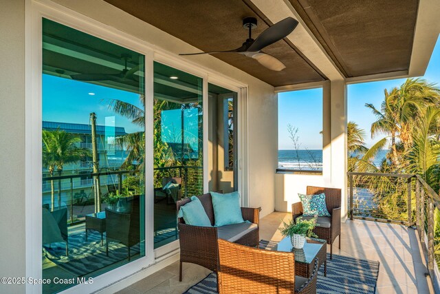 balcony with a water view, ceiling fan, and outdoor lounge area