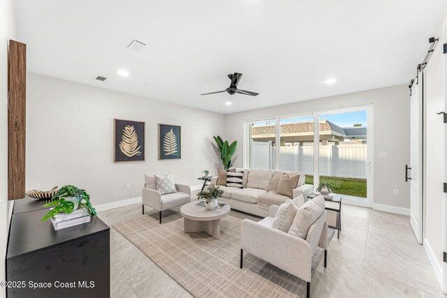 living room featuring ceiling fan and light tile patterned flooring