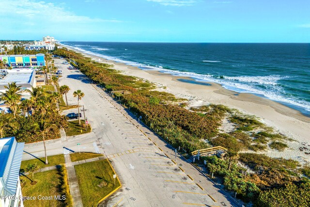 drone / aerial view with a water view and a view of the beach