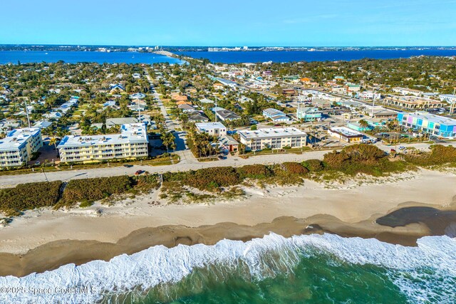 birds eye view of property with a view of the beach and a water view