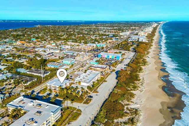 drone / aerial view with a beach view and a water view